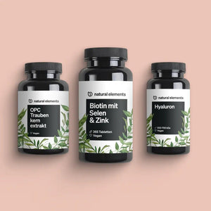 Drei Nahrungsergänzungsflaschen des Natural Beauty Bundle mit den Aufschriften OPC, Biotin mit Selen & Zink und Hyaluron auf pfirsichfarbenem Hintergrund, alle als vegan gekennzeichnet. Hergestellt aus natürlichen Elementen.